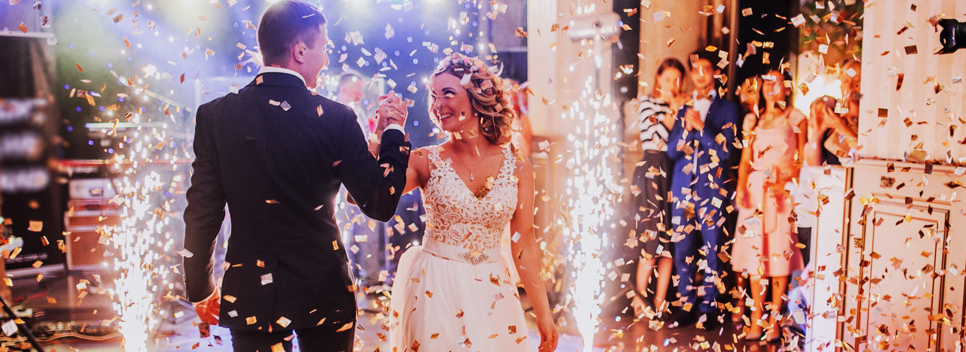 bride and groom dancing and confetti falling on them